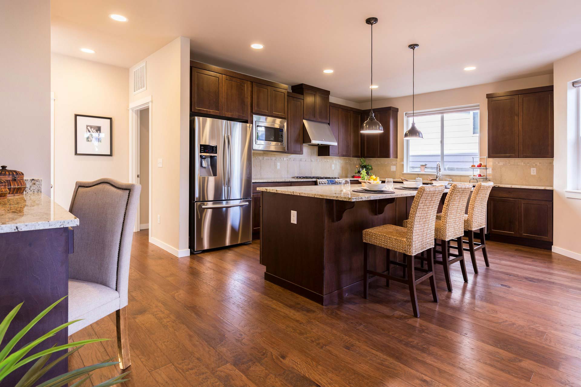 Newly renovated kitchen with wooden cabinets and wood floor