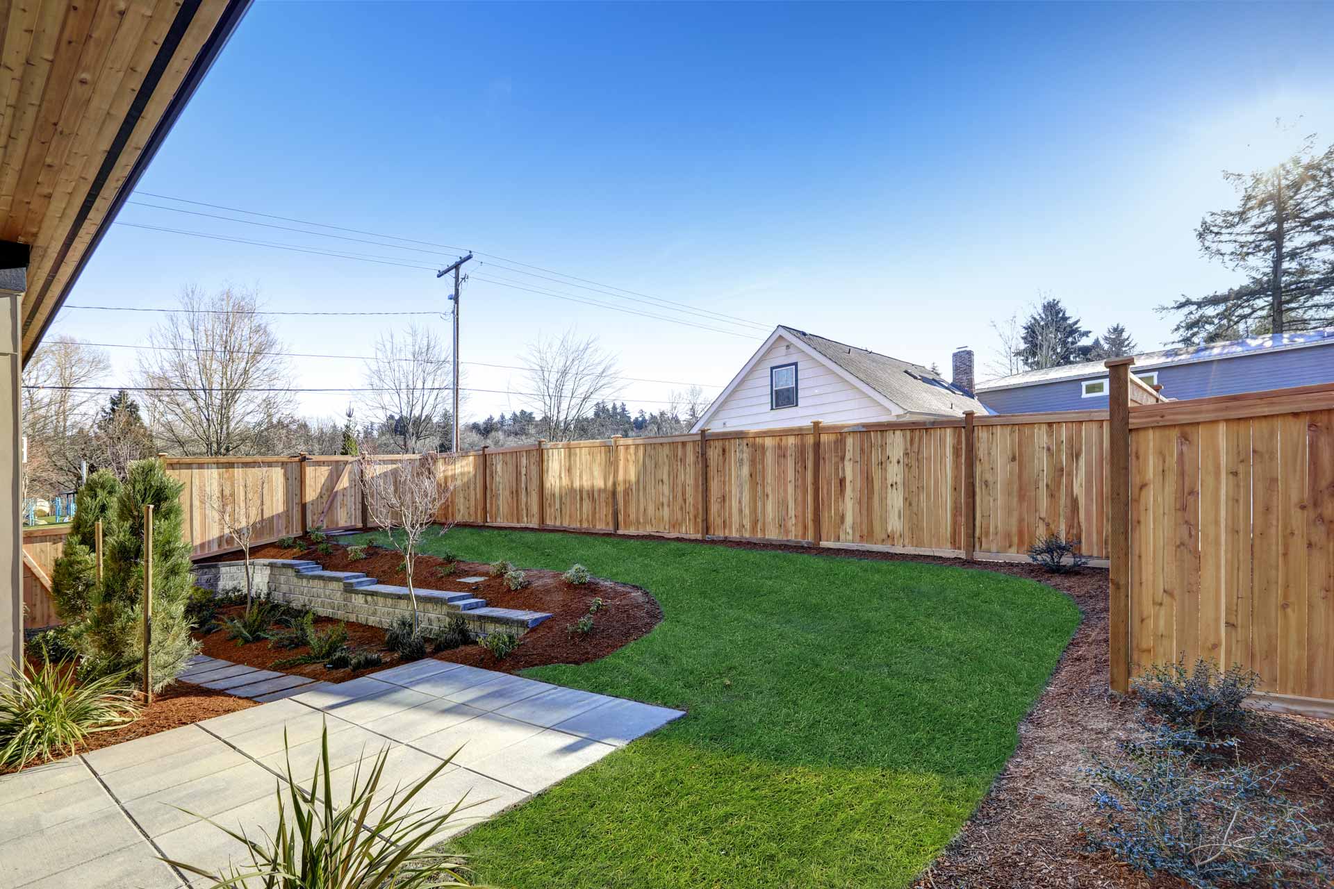 Well-landscaped backyard with a wooden privacy fence