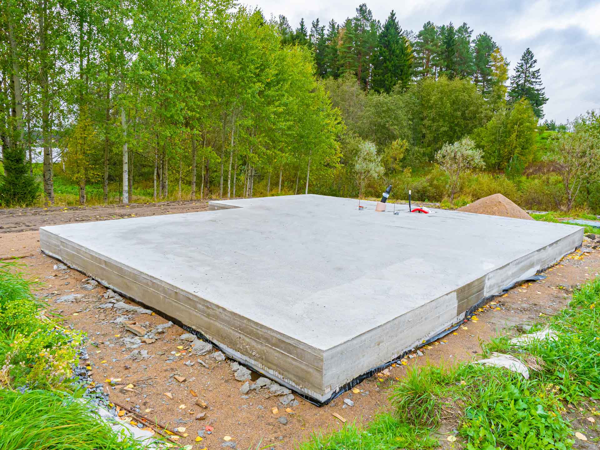 Newly poured concrete foundation for small cottage