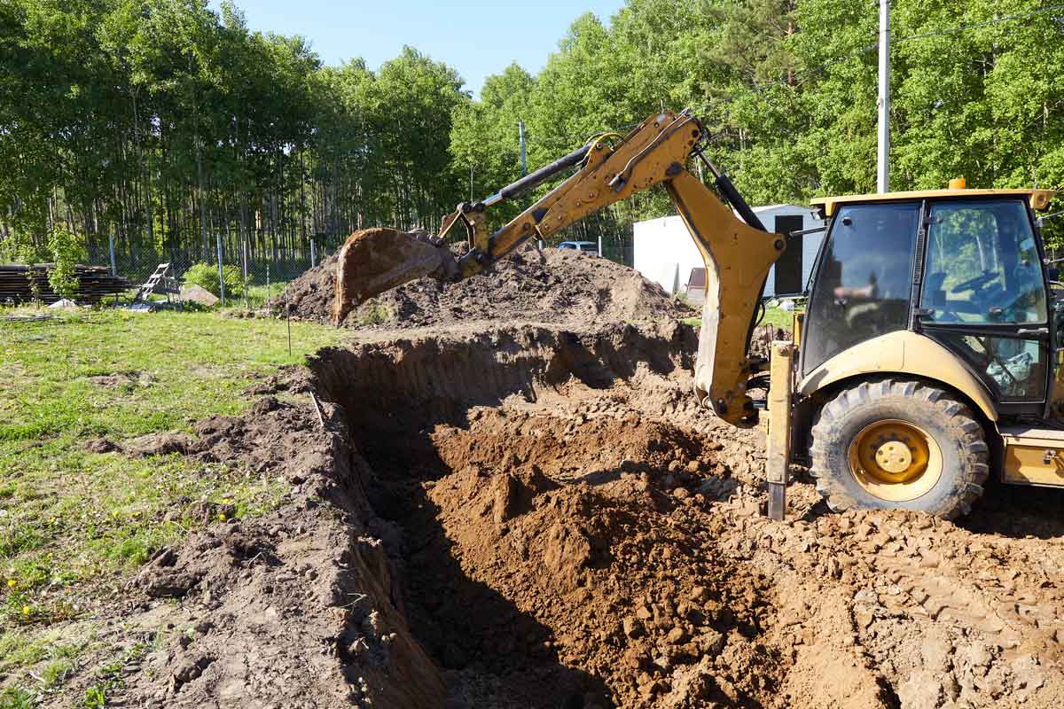 Excavator digging a trench